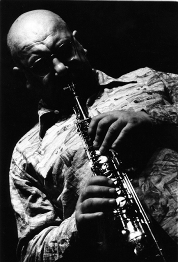 black and white photo of Lol Coxhill with head down playing saxaphone