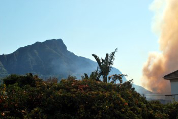 a pall of dense orange red smoke rising from the foot of devil's peak monster mountain