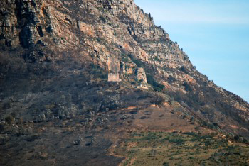 built from the same orange yellow sandstone as the mountain itself, the blockhouse survives the flames of the fire.