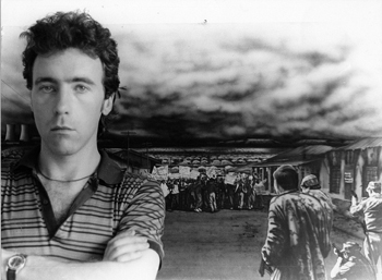 Black and white photo of Martin Lovis shown in front of his Soeto painting.