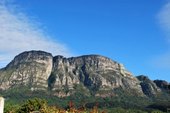 The five East Side buttresses stand out cold and grey against pale blue sky with high cirrus clouds and show almost no shadows on or between the craggy buttresses with no shadow face at all.
