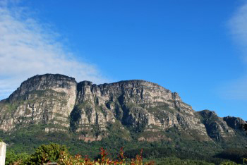 The five East Side buttresses stand out pale blue sky with high cirrus clouds and show almost no shadows on or between the craggy buttresses.