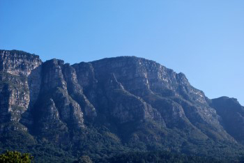 Mountain buttresses basking in cool hazy blue light with deep grey blue shadows and the mystical face changed into just a new shadow shape.