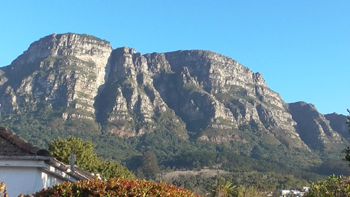 African shadow face appera s at dawn of new day on east side of Table Mountain.